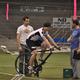 Trevor riding the bike as Cameron and Todd look on.